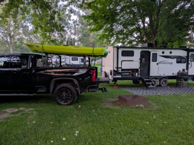 long term rv sites in bluffton RV Park campsite with travel trailer and kayaks at Bluffton Resort & Bar